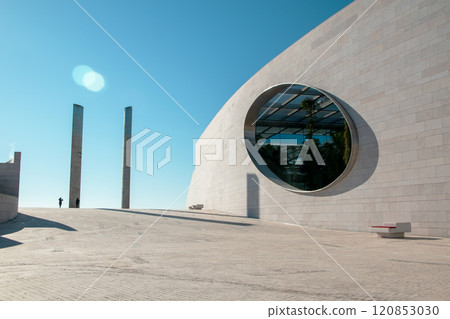 Futuristic landscape, Modern building architecture in the Champalimaud Foundation, oval windows in the wall leading to a garden with palm trees 120853030