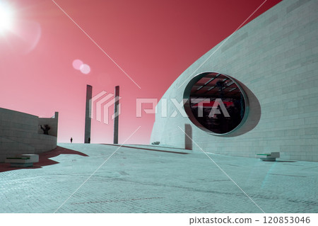 Futuristic landscape, Modern building architecture in the Champalimaud Foundation, oval windows in the wall leading to a garden with palm trees 120853046