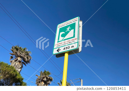 Tsunami evacuation sign on the coast of the Atlantic Ocean in Portugal Tsunami evacuation sign on the coast of the Atlantic Ocean in Portugal 120853411