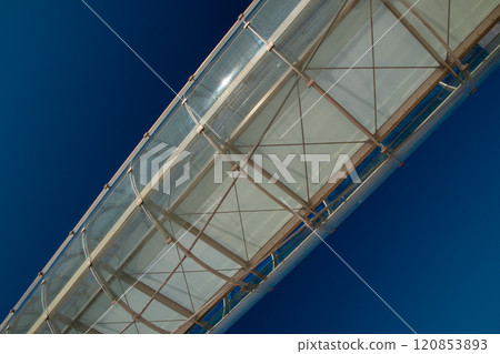 Glass bridge tunnel connecting two buildings, metal structure, modern architecture 120853893