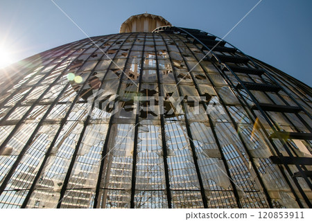 Broken glass roof dome of greenhouse consisting of rectangular panels in the park of Lisbon, Portugal 120853911