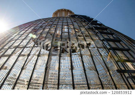 Broken glass roof dome of greenhouse consisting of rectangular panels in the park of Lisbon, Portugal 120853912