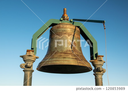 Big old bronze bell against the blue sky 120853989
