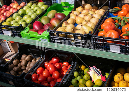 Fresh organic fruits and vegetables arranged on a market stand outside a shop in Lisbon, Portugal. 120854073