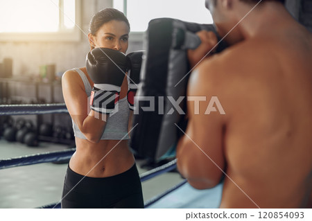 Engaging in an Intense Boxing Training Session at a StateoftheArt Modern Gym Facility Engaging in an Intense Boxing Training Session at a StateoftheArt Modern Gym Facility 120854093
