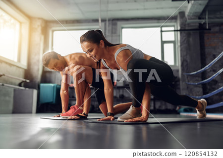 Engaging in a Dynamic and Energizing Workout Session in a Modern and Innovative Gym Environment 120854132