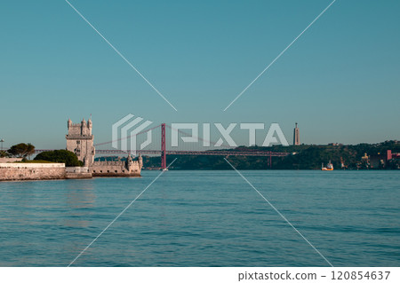 View of Tower of Belem and Ponte 25 de Abril Bridge at sunset, Lisbon, Portugal on the Tagus River View of Tower of Belem and Ponte 25 de Abril Bridge at sunset, Lisbon, Portugal on the Tagus River 120854637