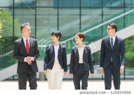 Businessmen walking in front of the office Businessmen walking in front of the office 120854998