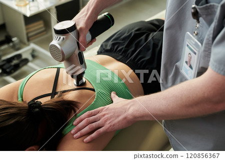 Delivering Massage Therapy with Electronic Massager Device 120856367