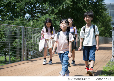 Smiling elementary school students going to school, multiple images Smiling elementary school students going to school, multiple images 120856377