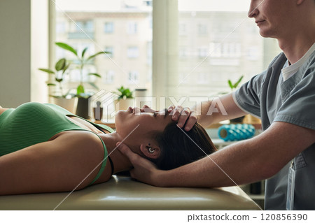 Receiving Relaxing Massage Therapy in Tranquil Setting Receiving Relaxing Massage Therapy in Tranquil Setting 120856390