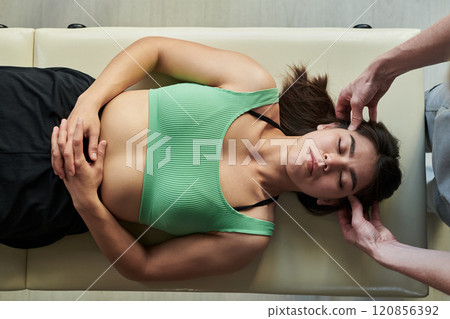 Receiving Chiropractic Adjustment During Wellness Routine Receiving Chiropractic Adjustment During Wellness Routine 120856392