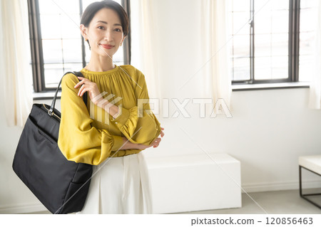 一名女子背著單肩包站在室內 120856463