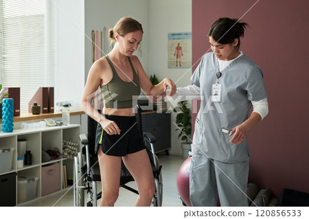 Assisting Patient during Rehabilitation Session 120856533