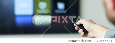 Hand Holding Remote Control While Using Smart TV Hand Holding Remote Control While Using Smart TV 120856644