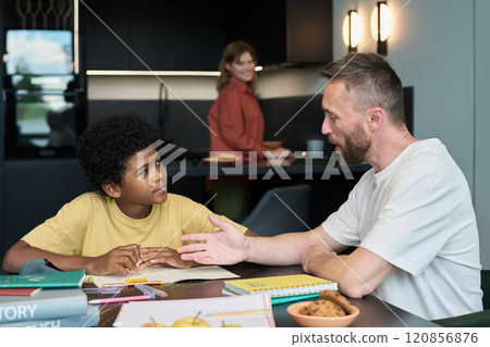 Engaging in Homework Activity with Family Member Engaging in Homework Activity with Family Member 120856876