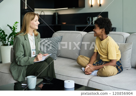 Smiling Therapist Engaging with Happy Young Patient Smiling Therapist Engaging with Happy Young Patient 120856904