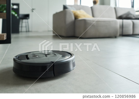 Robotic Vacuum Cleaner Navigating Modern Living Room 120856986