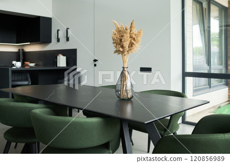 Modern Dining Area Featuring Green Chairs and Minimalist Decor 120856989