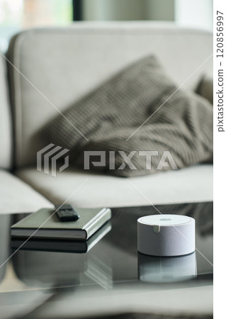 Smart Voice Assistant Device on Glass Coffee Table 120856997