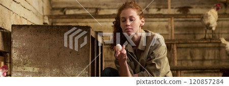 Young farmer holding fresh egg in hand Young farmer holding fresh egg in hand 120857284