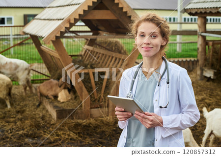 Young smiling veterinarian with tablet Young smiling veterinarian with tablet 120857312