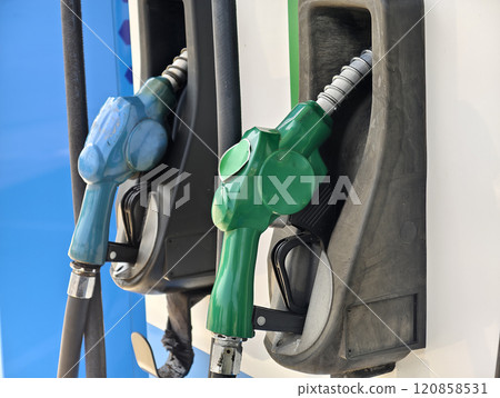 Fuel dispenser nozzles for various types of fuel, arranged at a gas station. Fuel dispenser nozzles for various types of fuel, arranged at a gas station. 120858531