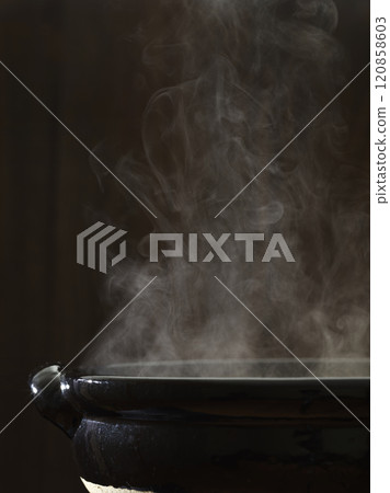Image of hot pot cooking with steam rising from a clay potImage of hot pot cooking with steam rising from a clay pot 120858603