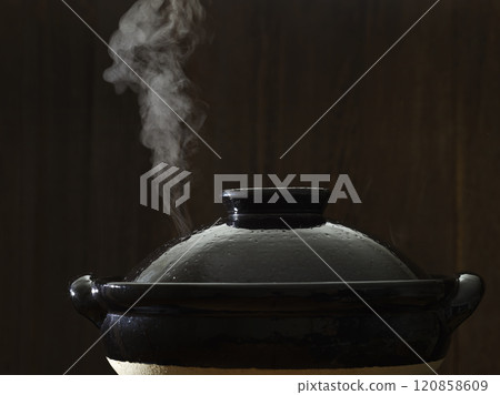 Image of hot pot cooking with steam rising from the clay pot 120858609