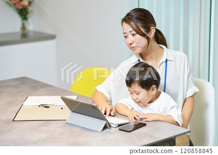 A woman working with a child A woman working with a child 120858845