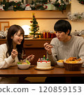 Couple eating Christmas cake 120859153