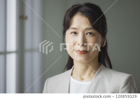 A middle-aged business woman thinking A middle-aged business woman thinking 120859329
