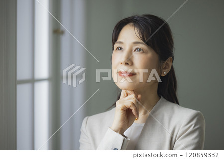 A middle-aged business woman thinking 120859332