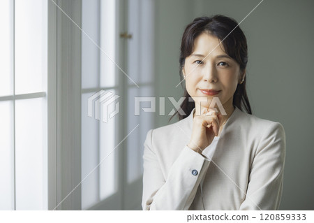 A middle-aged business woman thinking A middle-aged business woman thinking 120859333