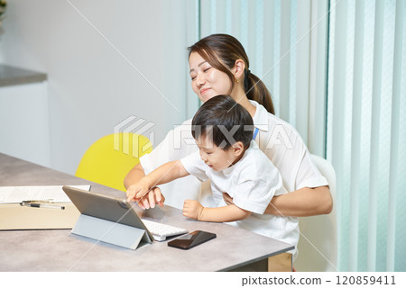 Boy disturbing his mother at work 120859411