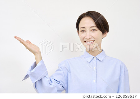 Woman pointing to the left with her palm on a white background Woman pointing to the left with her palm on a white background 120859617