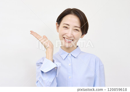 Woman pointing to the left with her palm on a white background Woman pointing to the left with her palm on a white background 120859618
