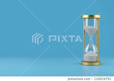 A golden hourglass with flowing sand on a blue background 120859791