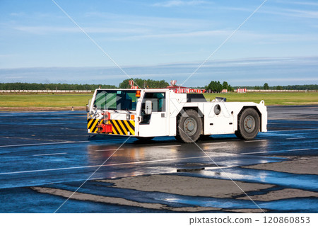 Airplane tow tractor at the airport apron Airplane tow tractor at the airport apron 120860853