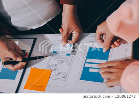 Young Asian business creative team work together, mobile application software design project. Brainstorm meeting, internet technology, smartphone web app designer, office coworker teamwork concept Young Asian business creative team work together, mobile application software design project. Brainstorm meeting, internet technology, smartphone web app designer, office coworker teamwork concept 120861278