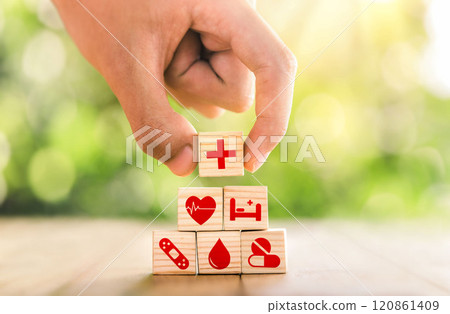 Hand arranged wooden blocks with icons of medical health. health insurance for your health concept. Healthcare medical business, medical technology equipment icon. Hand arranged wooden blocks with icons of medical health. health insurance for your health concept. Healthcare medical business, medical technology equipment icon. 120861409