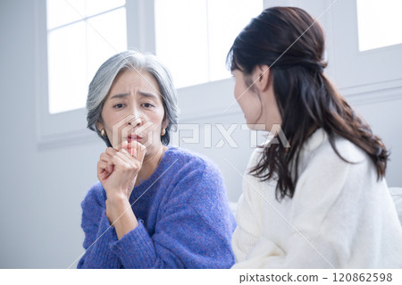 A daughter listens to her elderly mother's concerns and a mother is confused and troubled. Negative images of being scolded by her daughter 120862598