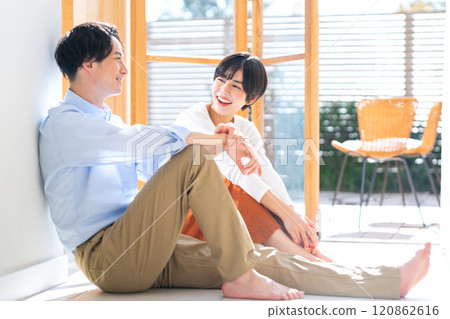 Couple relaxing in the sunroom Couple relaxing in the sunroom 120862616