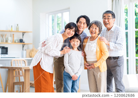 Three-generation family relaxing in the living room 120862686