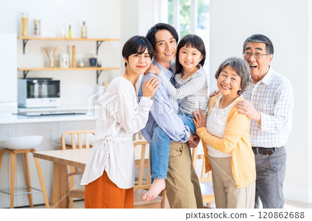Three-generation family relaxing in the living room 120862688