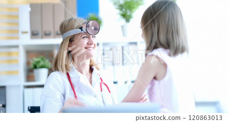 Female doctor at the clinic smiling at the girl Female doctor at the clinic smiling at the girl 120863013