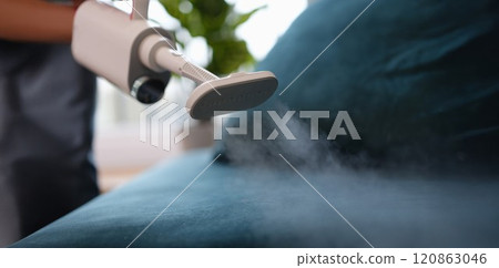 Steam comes out of the vacuum cleaner above the sofa Steam comes out of the vacuum cleaner above the sofa 120863046