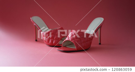 Pink slides with heels on a pink background Pink slides with heels on a pink background 120863059