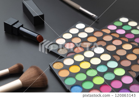 Eyeshadow palette and makeup tools on a black background Eyeshadow palette and makeup tools on a black background 120863143