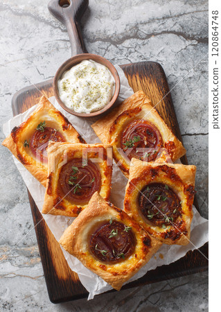 Upside-Down Onion Tartlets sweet, tangy, and totally delicious closeup on the wooden board. Vertical top view Upside-Down Onion Tartlets sweet, tangy, and totally delicious closeup on the wooden board. Vertical top view 120864748